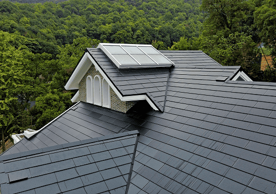 Installer preparing a roof base for an integrated solar roof system