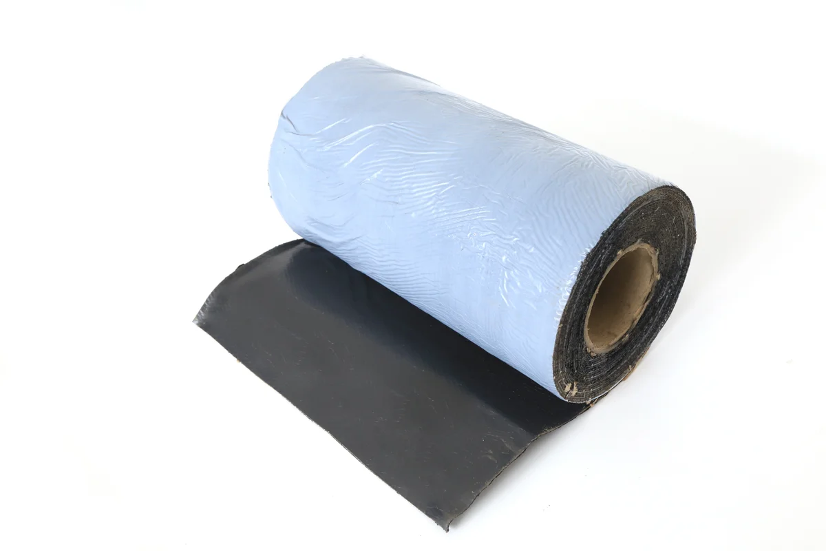 Flexible black flashing roll with protective backing for waterproof solar roof junctions.