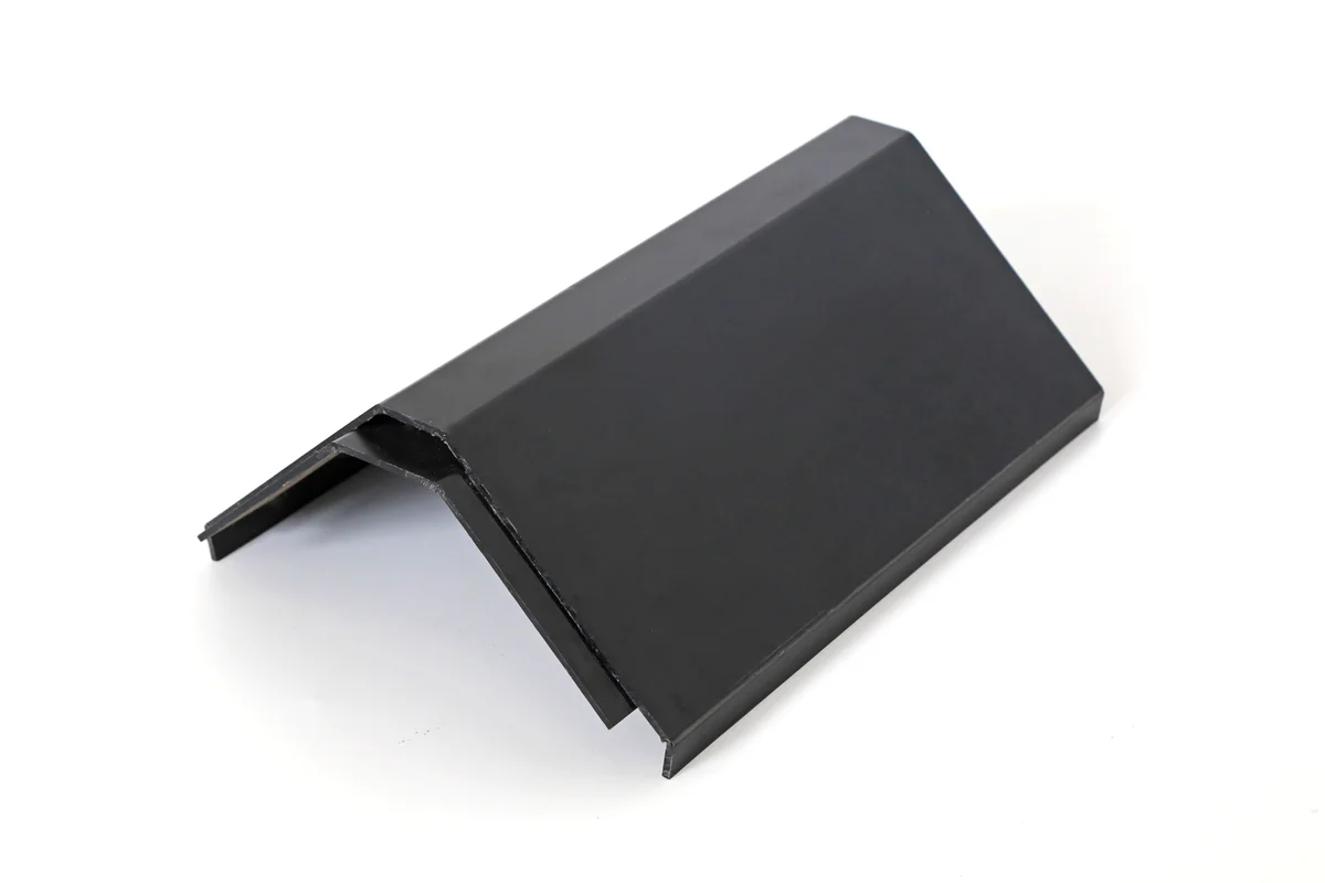 Black metal ridge tile for capping the peak of a Lumina Slate solar roof.