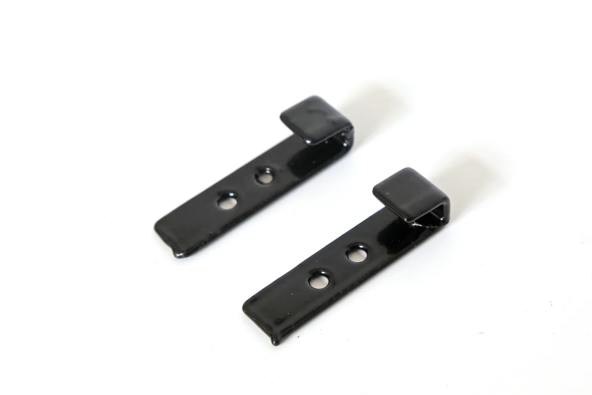 Pair of black metal wind-uplift clips for securing Lumina Slate roof tiles.