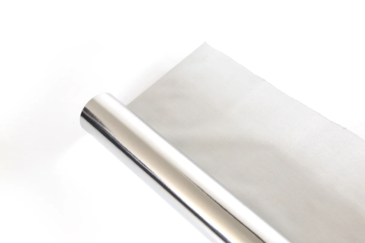 Reflective foil radiant barrier sheet for use beneath a solar roof assembly.