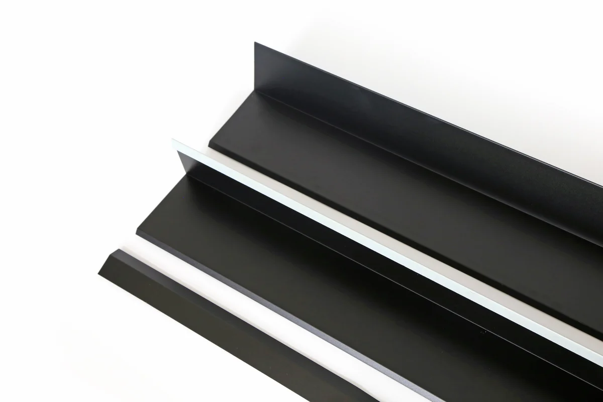 Black folded metal flashing boards for Storm Guard solar roof transitions.