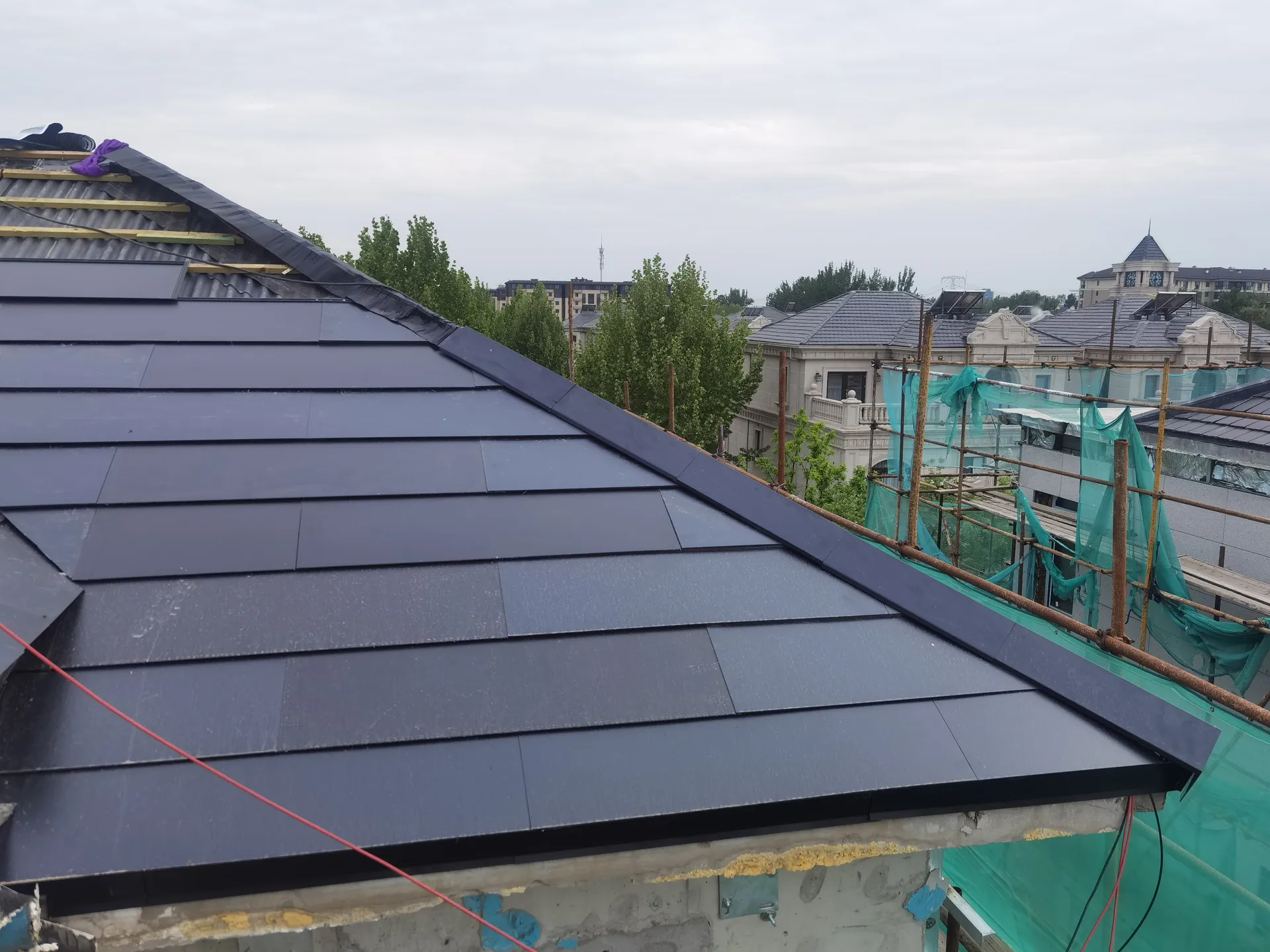 Installation of Sunlit solar roof tiles over the breathable wooden batten framework and underlayment.
