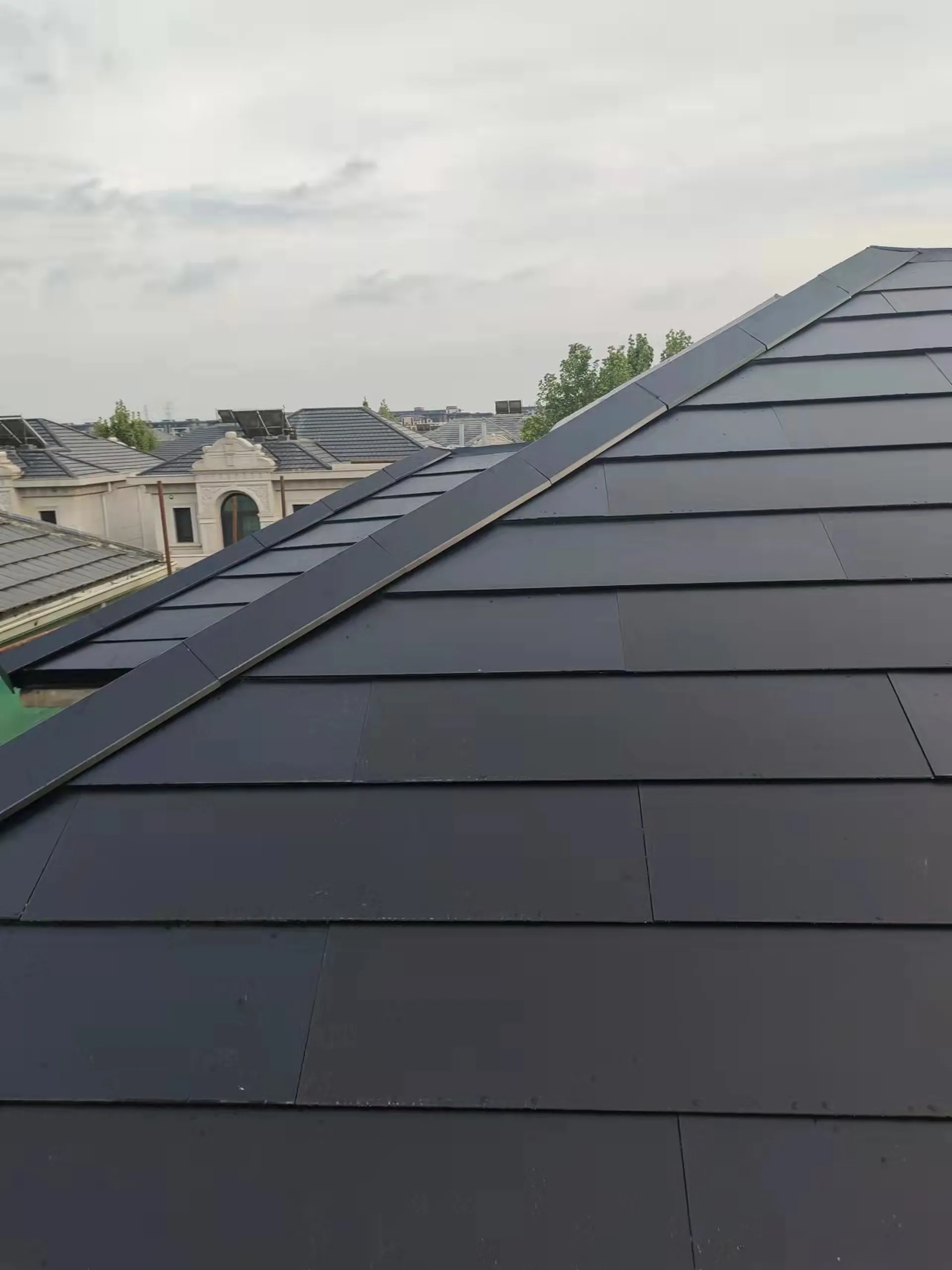 Sleek edge finish of the Sunlit solar slate roof on a high-end Beijing residential project.