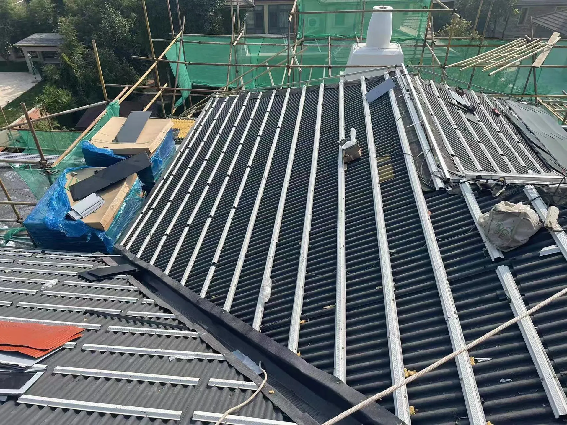Exposed roof structure showing the aluminum batten framing for the Lumina Slate BIPV system.