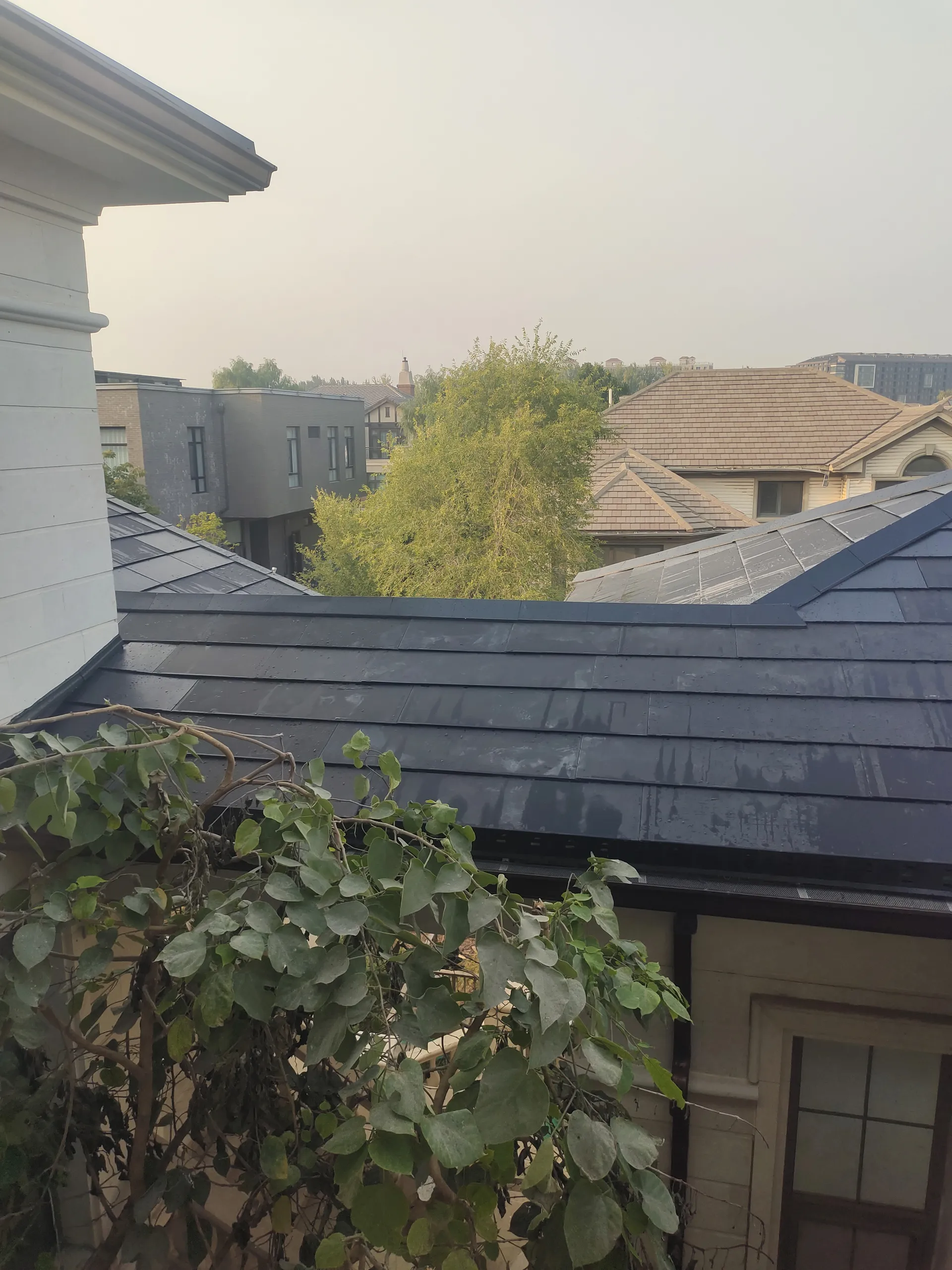 Close-up details of the seamless multi-hip roof installation using Lumina Slate solar tiles.