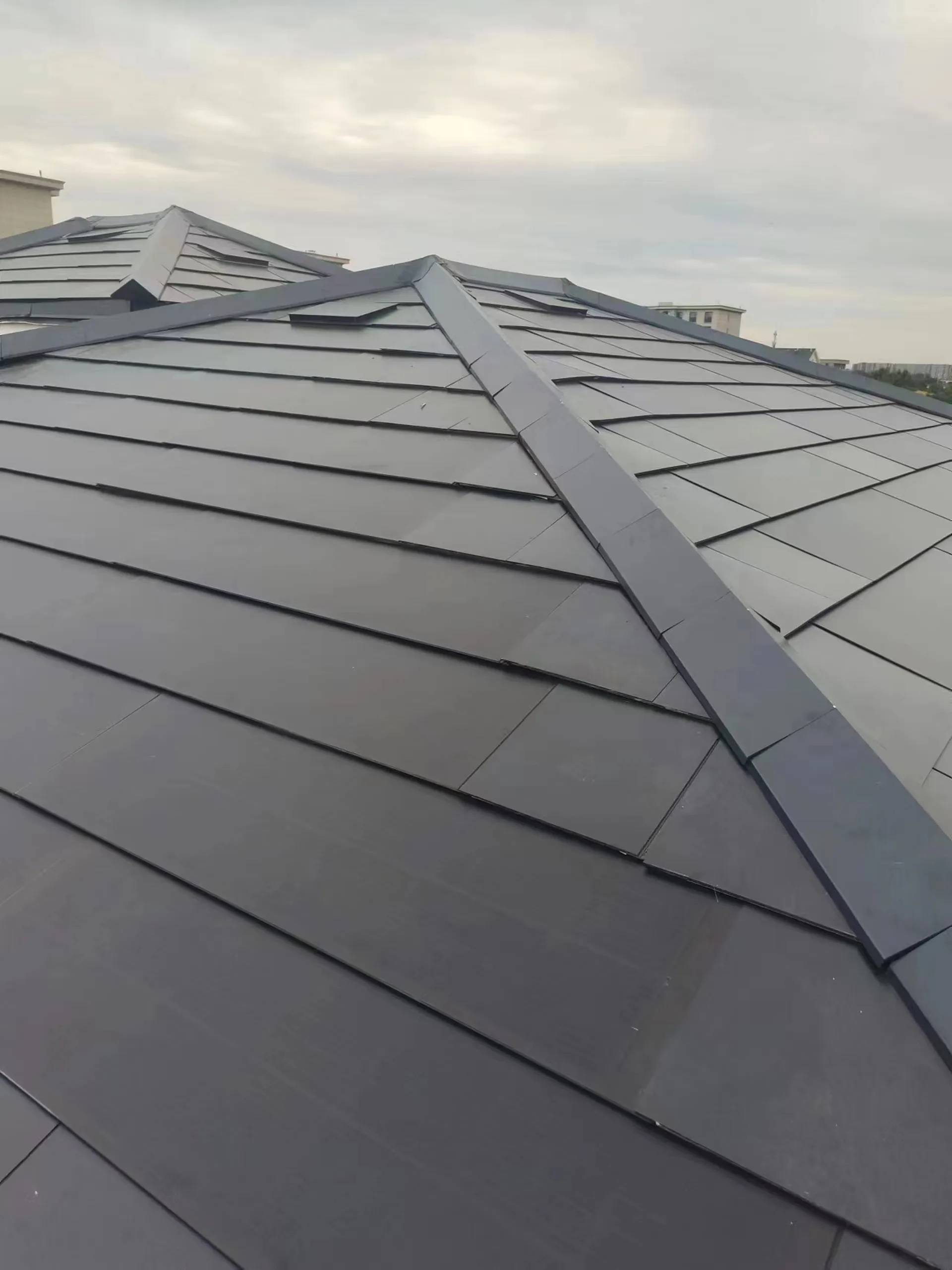 Close-up of the DC wiring and structural battens before the final solar tiles are locked into place.