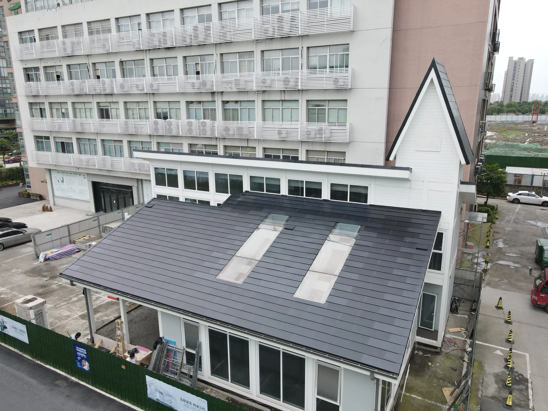 High-angle view highlighting the flush integration of large skylights within the solar roof system.