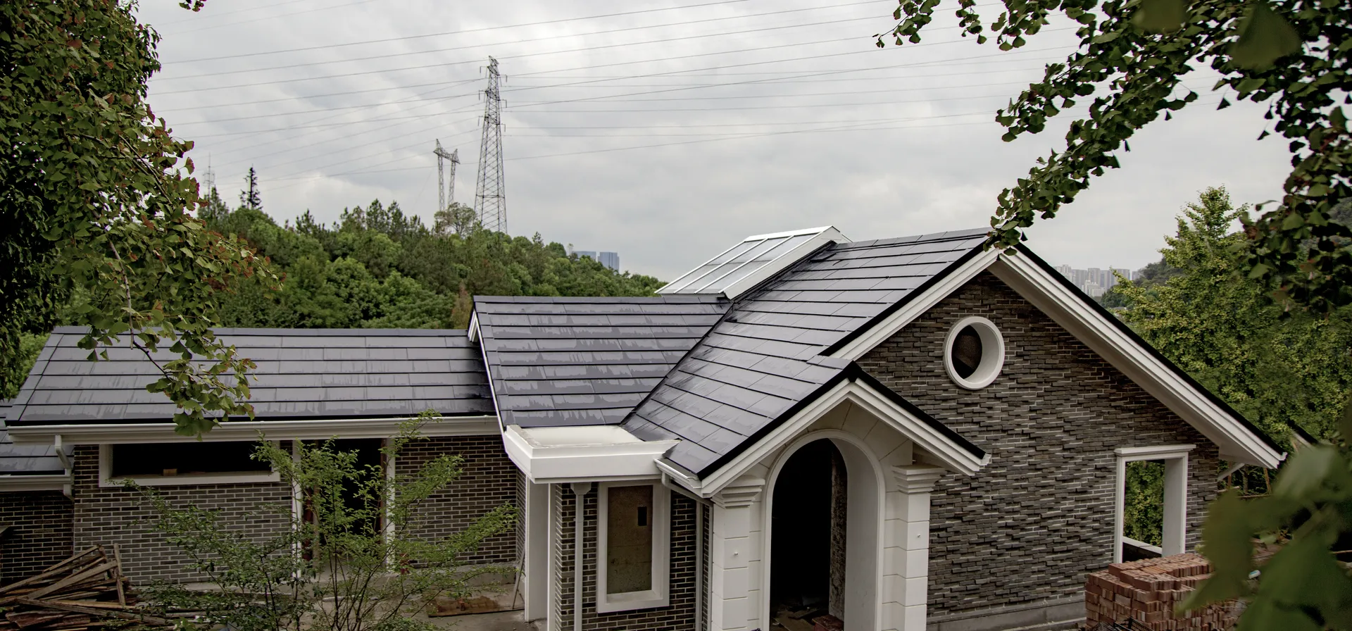 Aerial perspective of the completed, sleek Sunlit solar tile roof on a grey brick villa in Xianghu Arcadia.