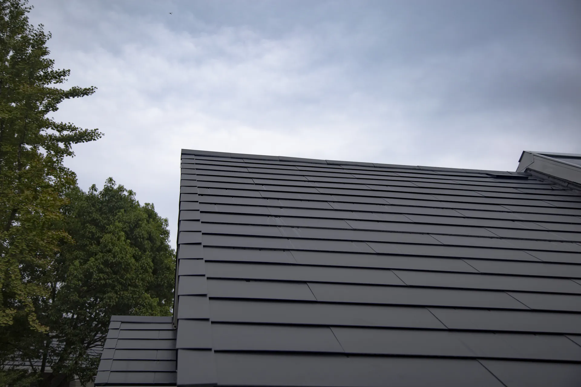 Macro close-up showcasing the fine texture and interlocking details of the installed Sunlit solar slates.
