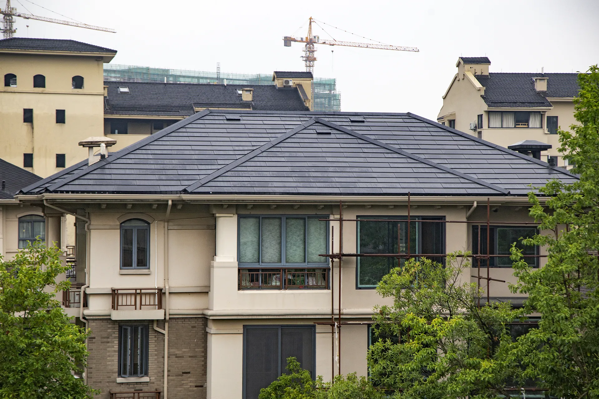 View of the completed Sunlit solar slate roof, showcasing its flawless adaptation to a complex multi-hip architectural design and discreet vents.