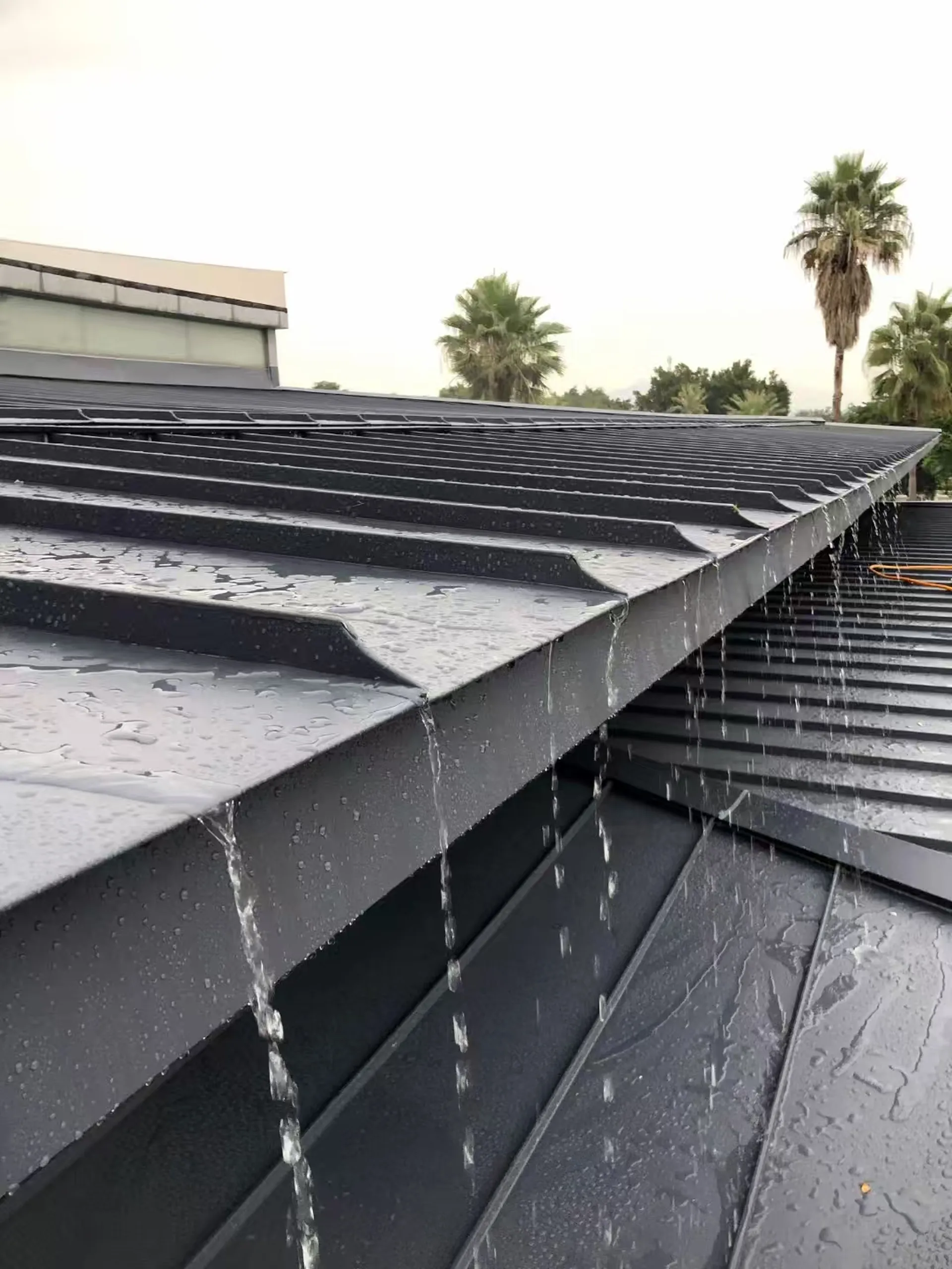 Demonstration of the Storm Guard solar roof efficiently shedding massive amounts of water during extreme torrential rain.