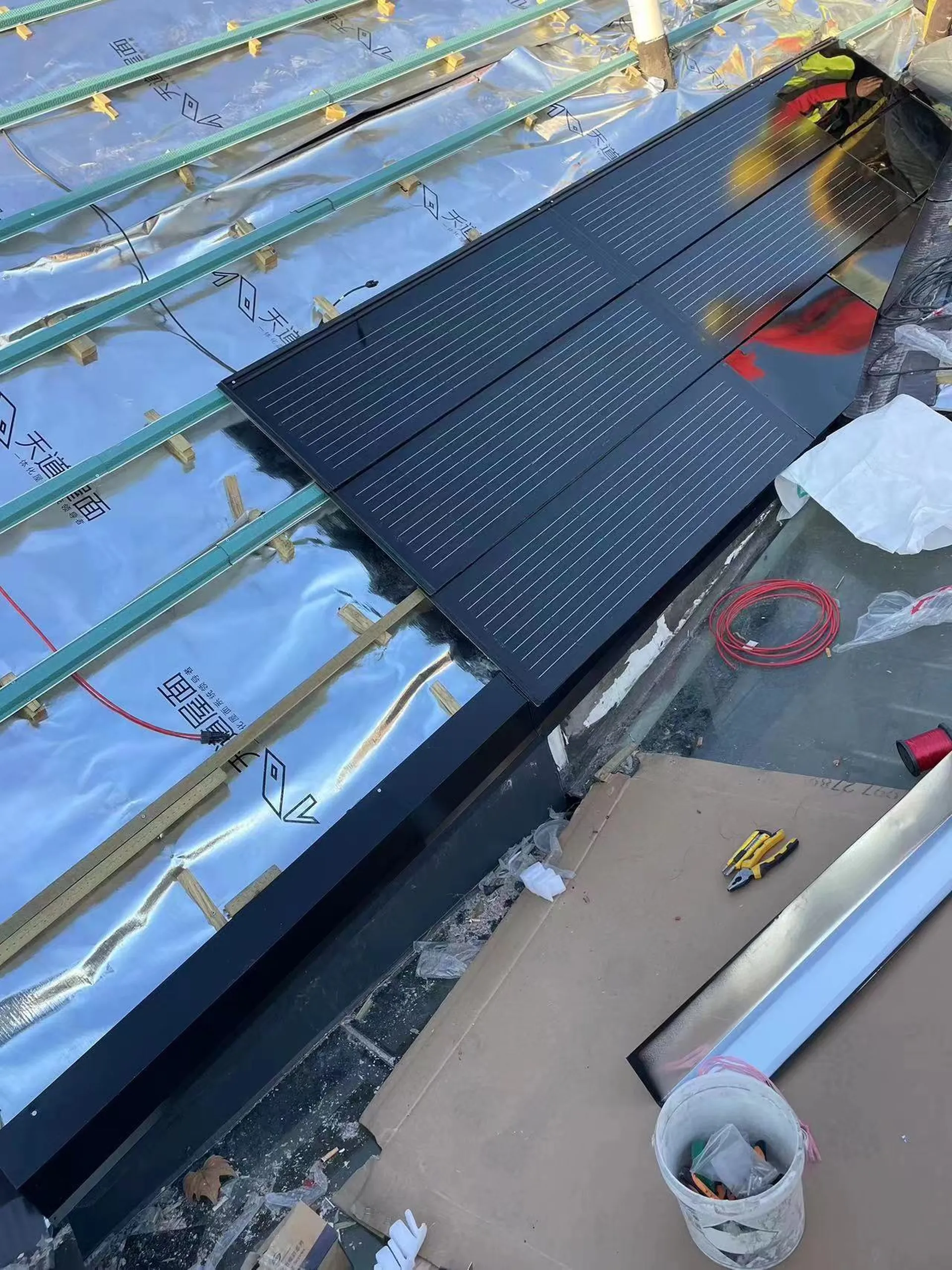 Aerial perspective of a modern residence featuring a seamless, horizontal-layout integrated solar roof.