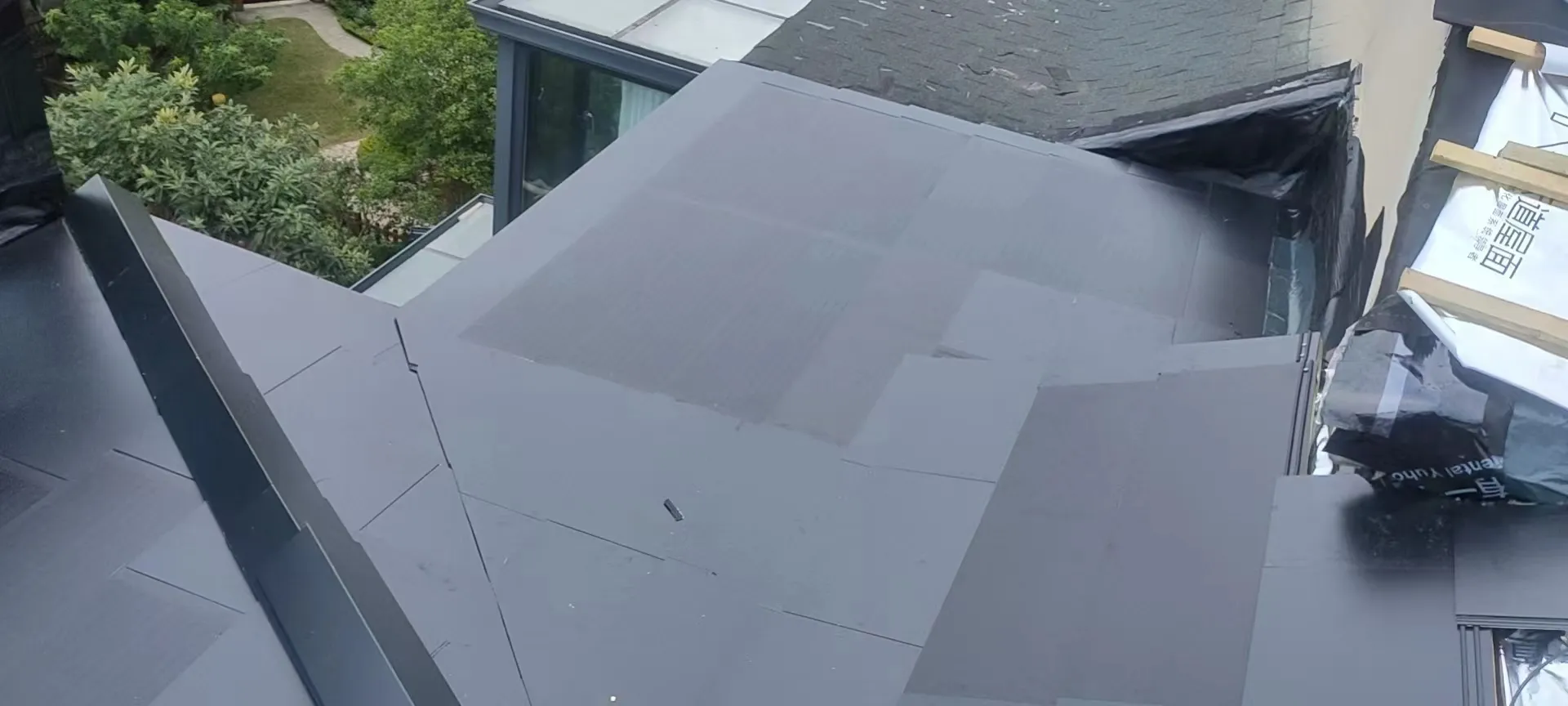 Close-up of the solar roof installation process, highlighting the precision flashing and watertight edge integration.