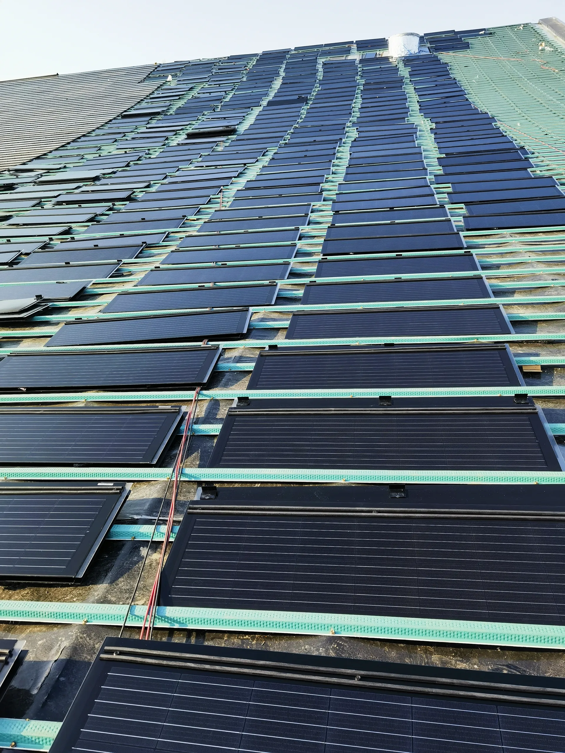 Looking up the roof slope at the robust rail substructure prepared for the large-scale solar array.