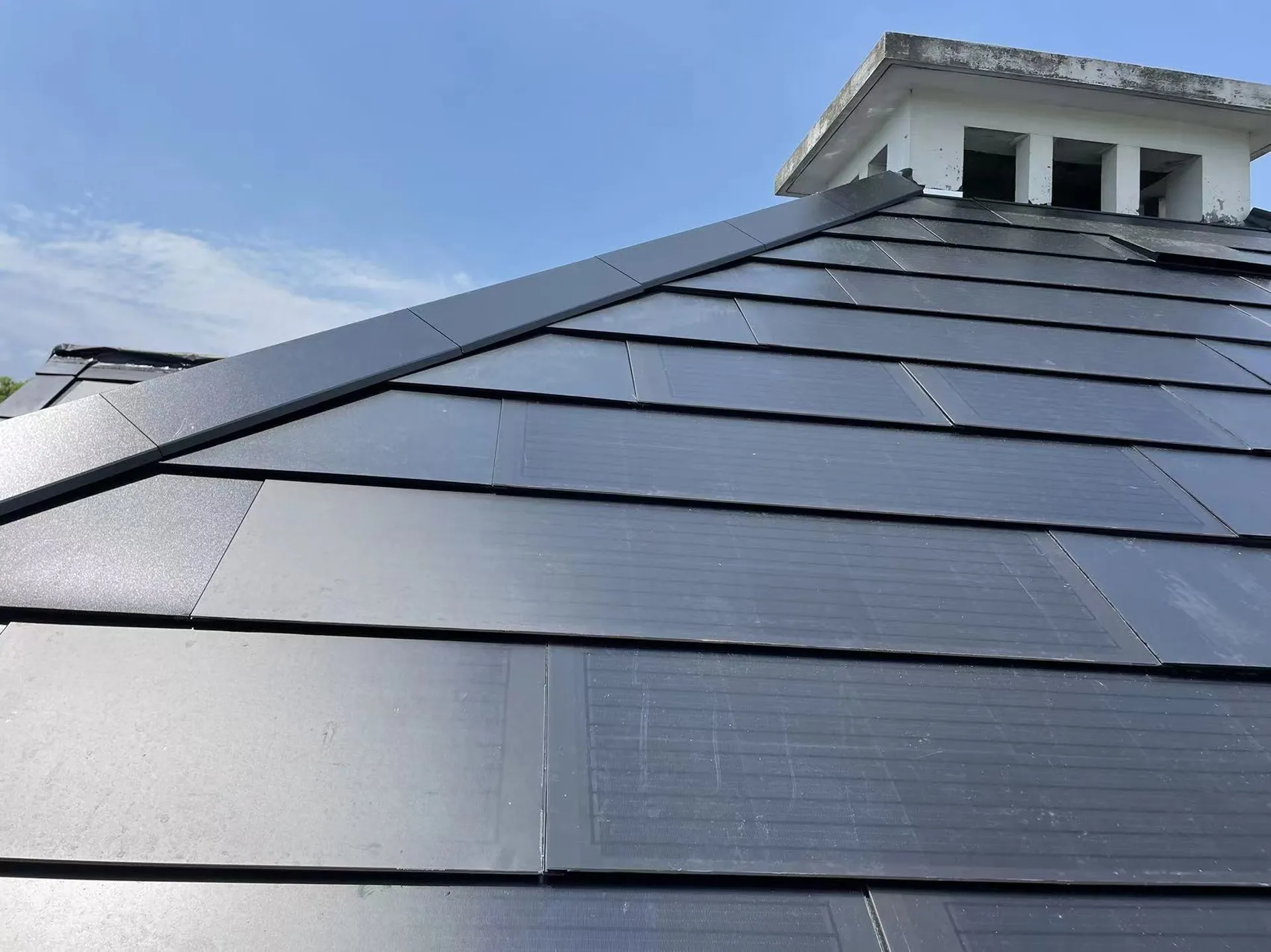 Close-up of the Sunlit solar slate roof ridge, highlighting the sleek, seamless surface and premium waterproof finish.