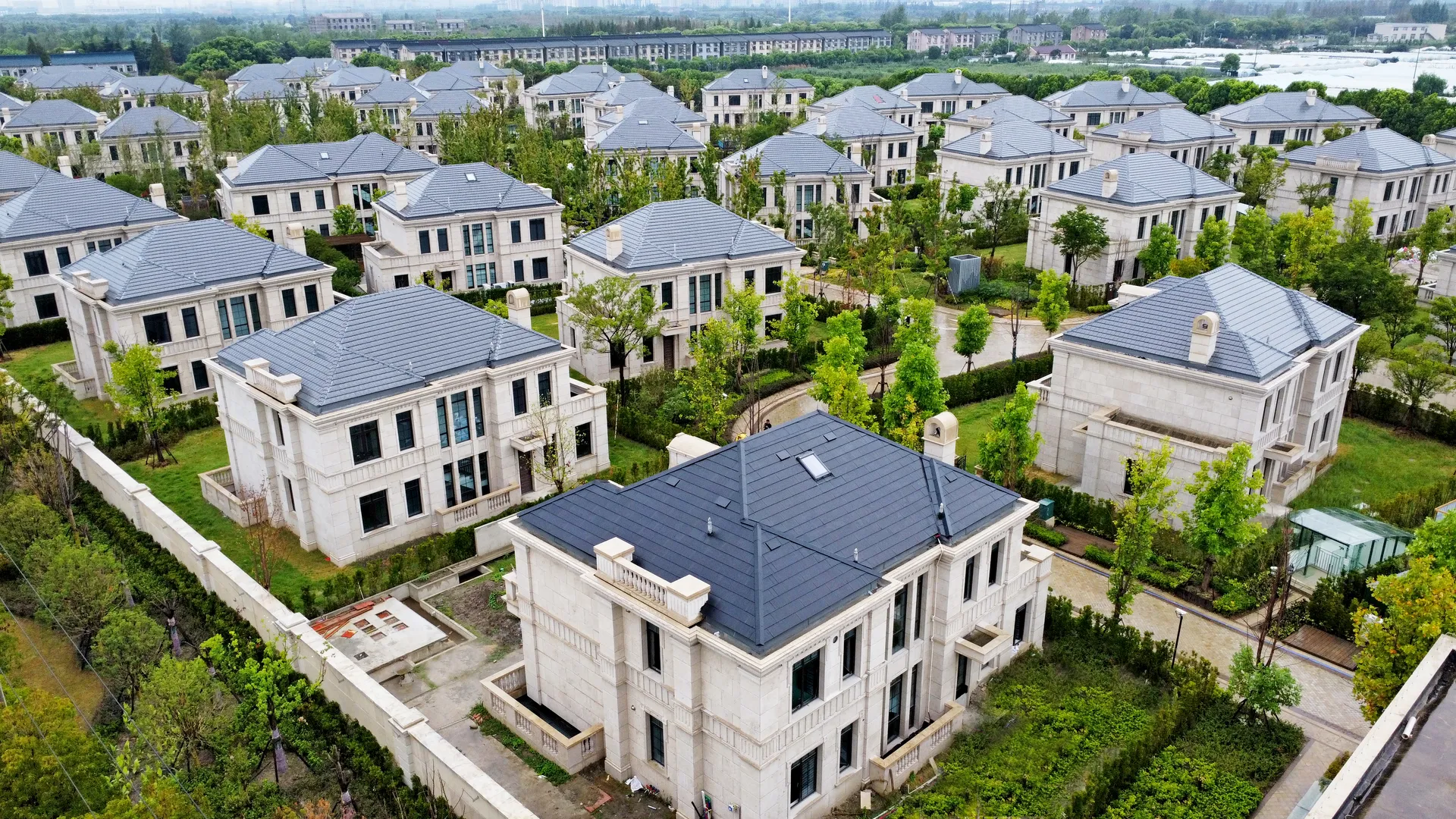 Aerial view of the premium Hongqiao Royal Villa community in Shanghai, highlighting a modern Sunlit BIPV solar roof upgrading the neighborhood aesthetic.