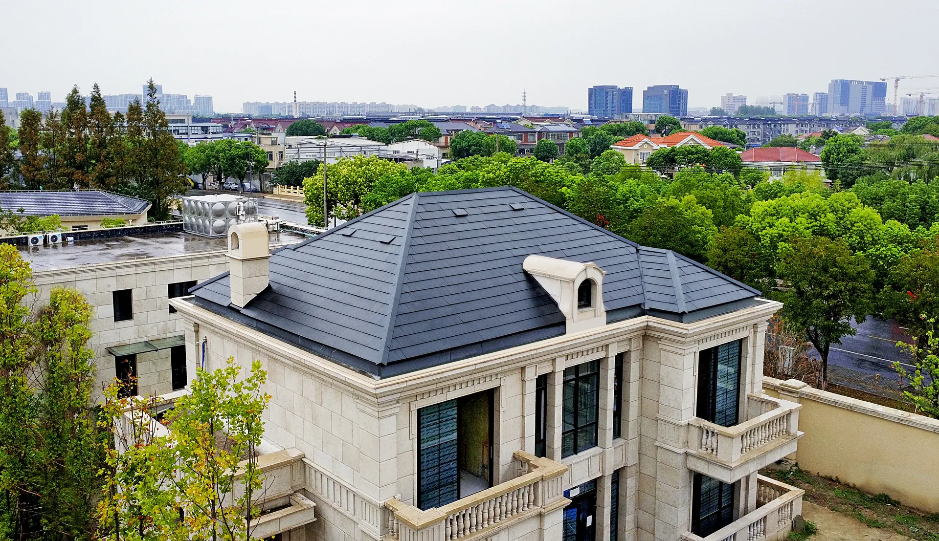 Aesthetic integration of an invisible solar roof with classic architectural elements like stone facades, chimneys, and dormer windows.