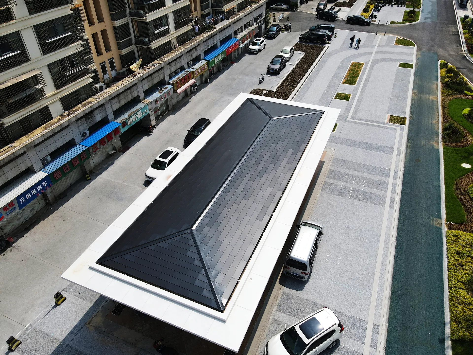 High-angle shot of the urban relay facility utilizing aesthetic solar power without compromising public space design.