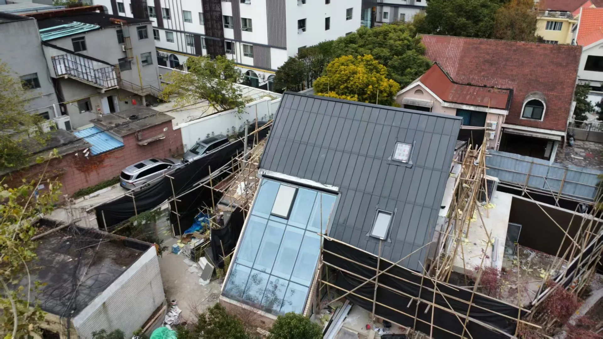 Seamless and watertight integration of a large modern glass skylight within the durable Storm Guard solar roofing system.