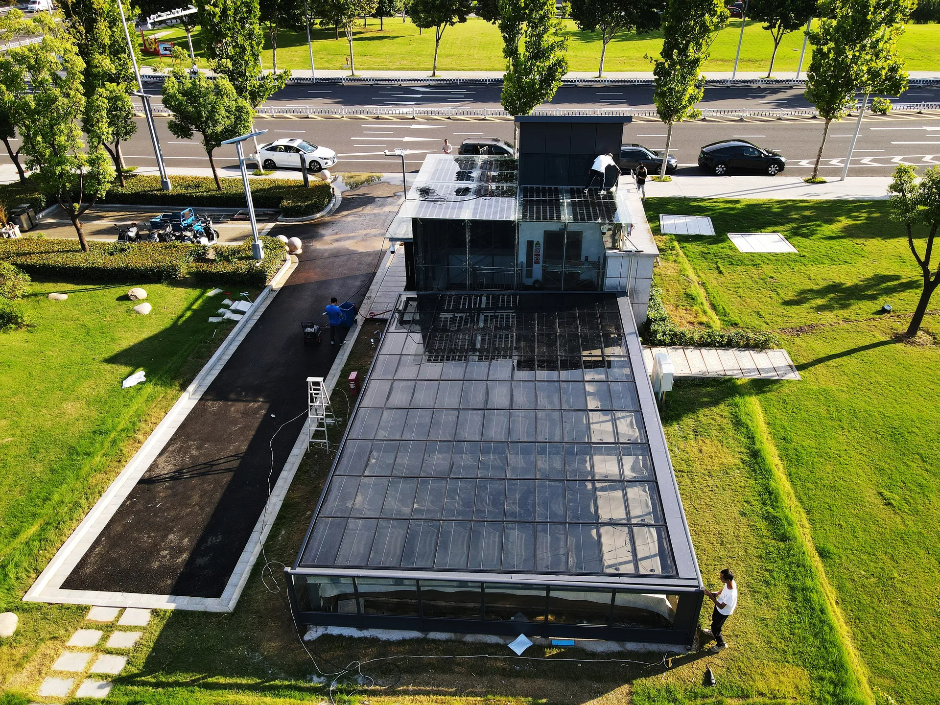 Aerial view of the all-in-one BIPV pavilion, showcasing integrated solar tiles and a solar glass sunroom roof.