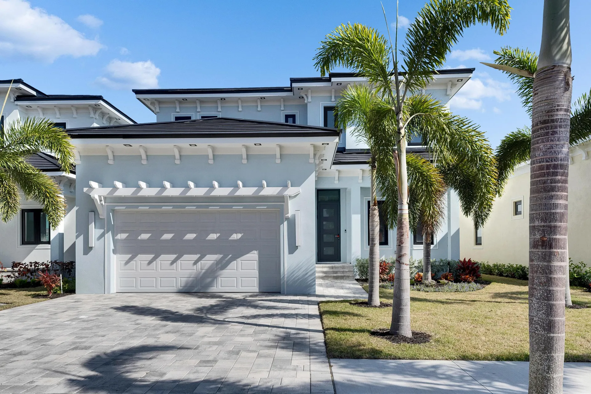 Front facade of a modern US home highlighting the clean, edge-to-edge finish of the Lumina Slate solar roof.