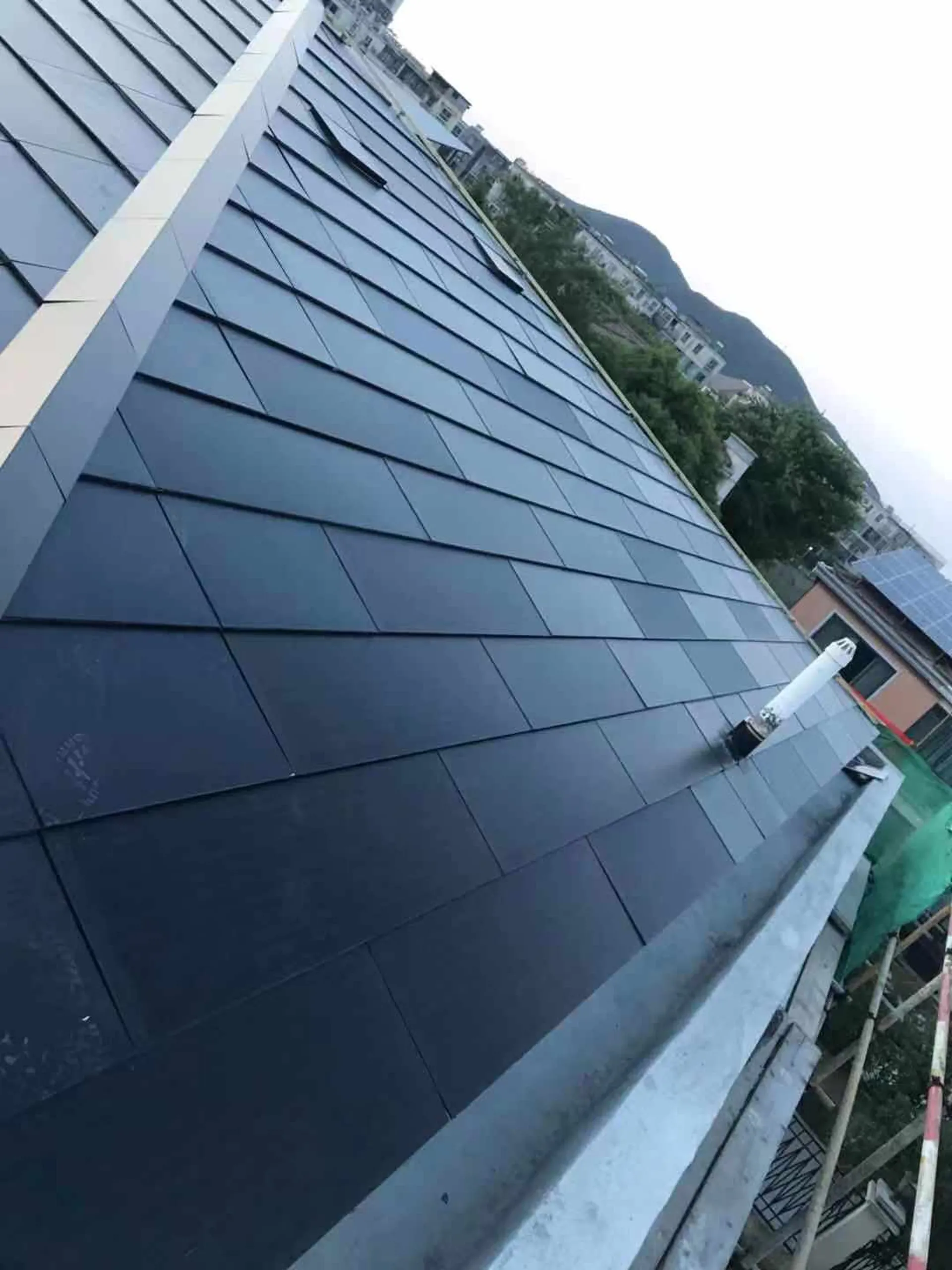 Detail shot of a roof vent pipe flawlessly integrated into the waterproof Sunlit BIPV roofing system.